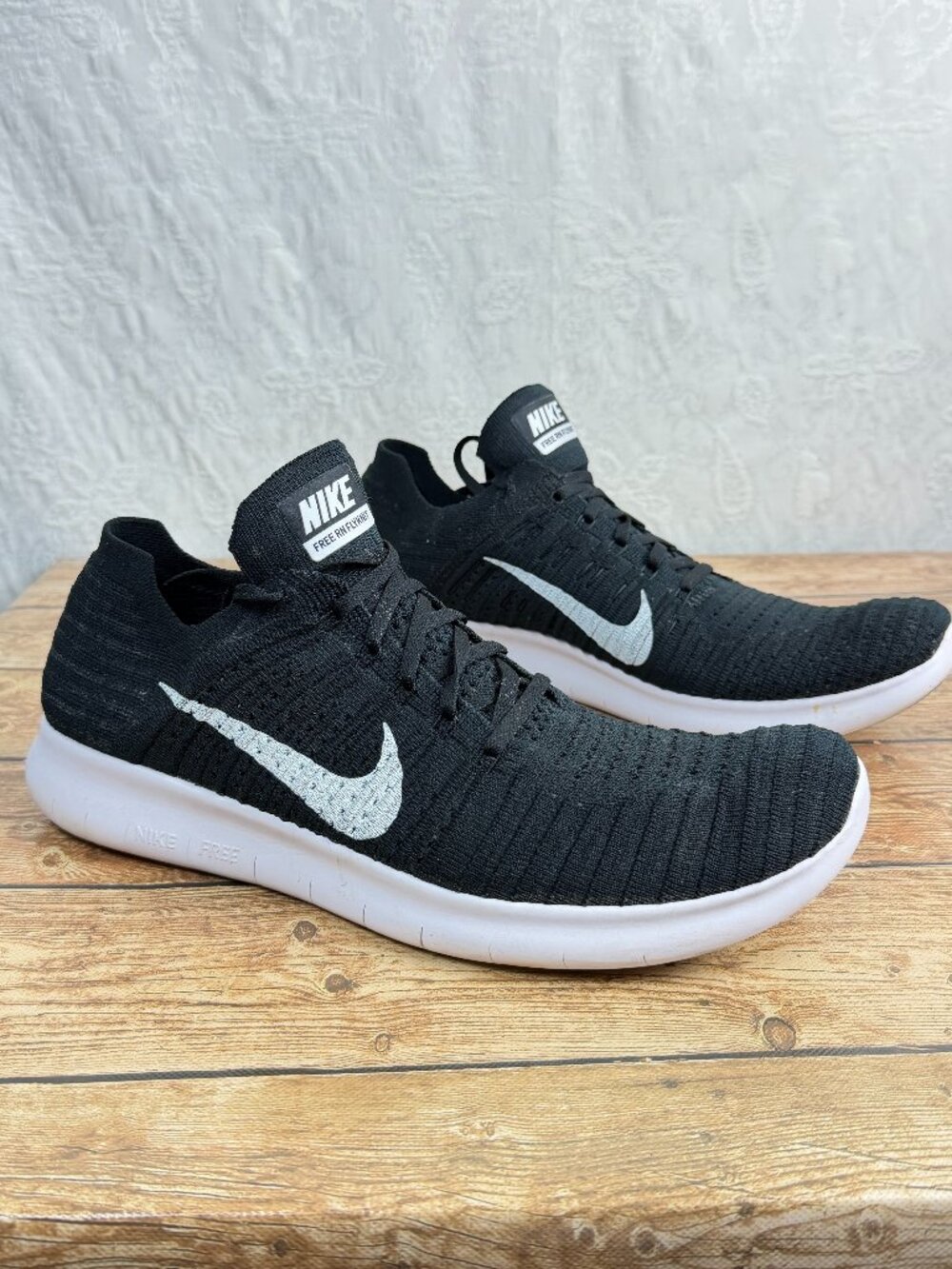 Nike Free RN Flyknit men’s running shoes in a classic Black/White colorway
